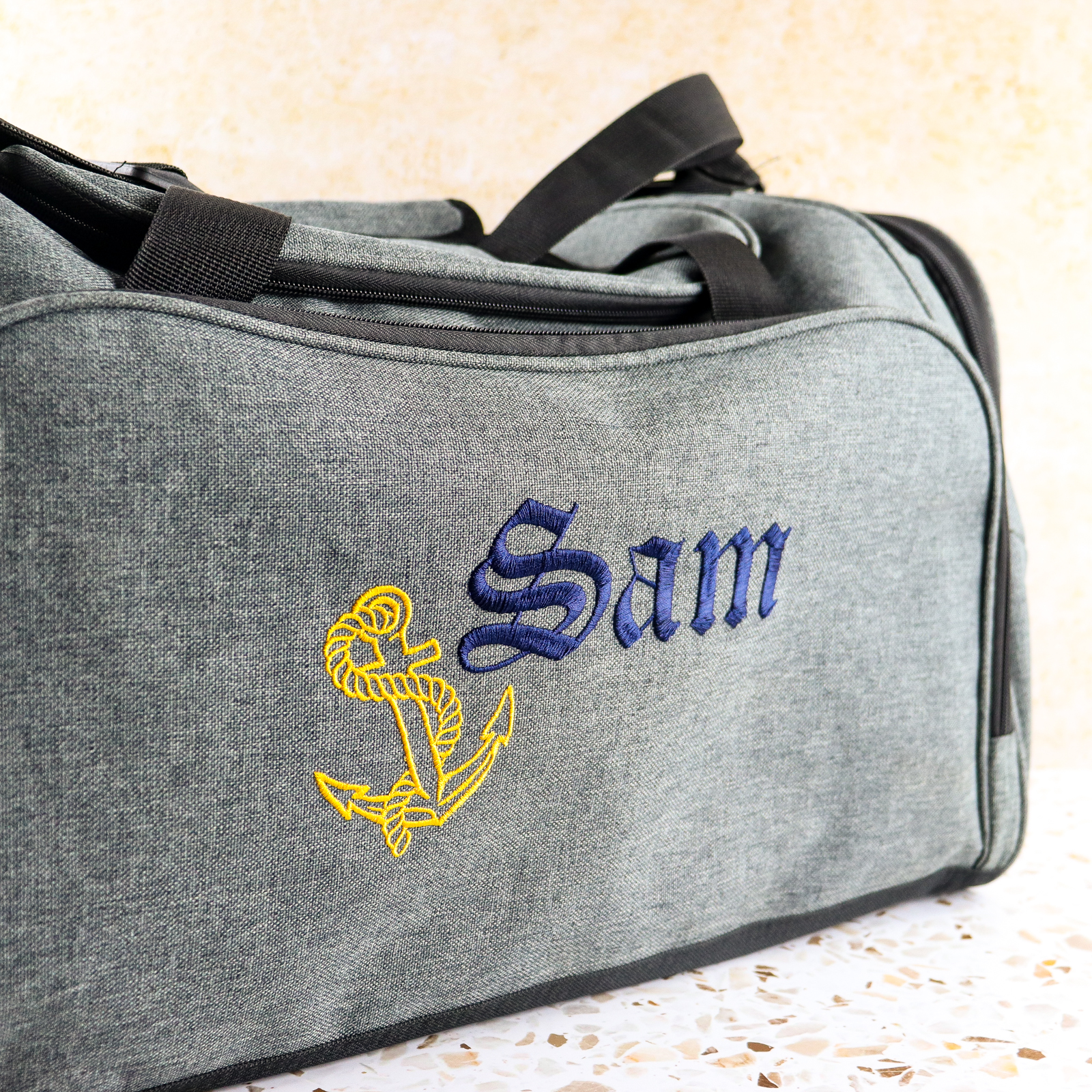 Embroidered grey duffle bag with personalised design