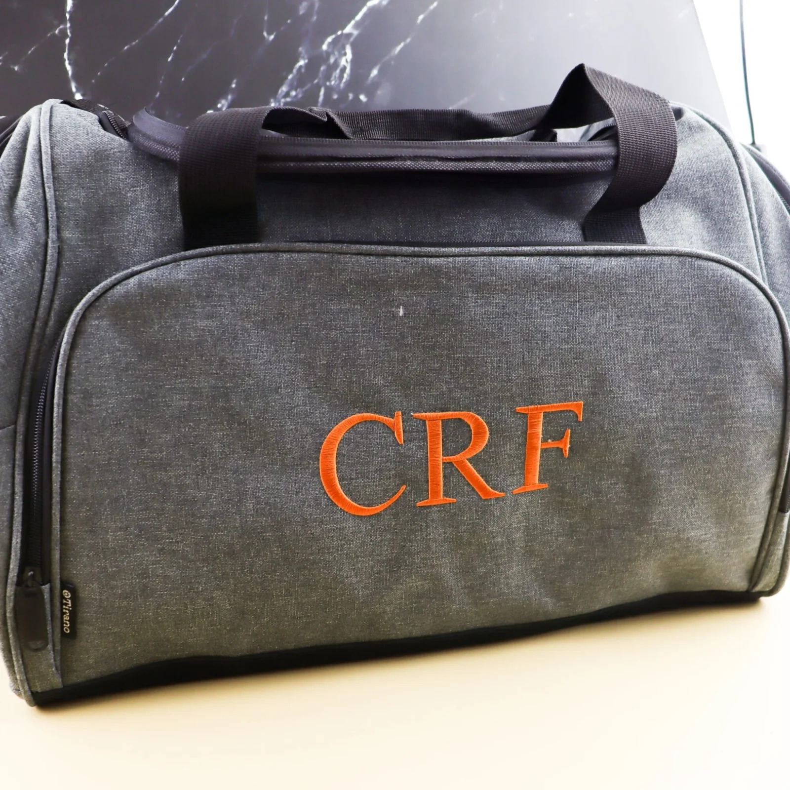 Embroidered grey duffle bag with personalised design