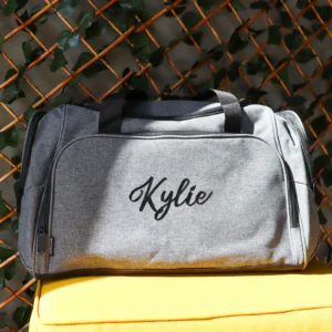 Embroidered grey duffle bag with personalised design